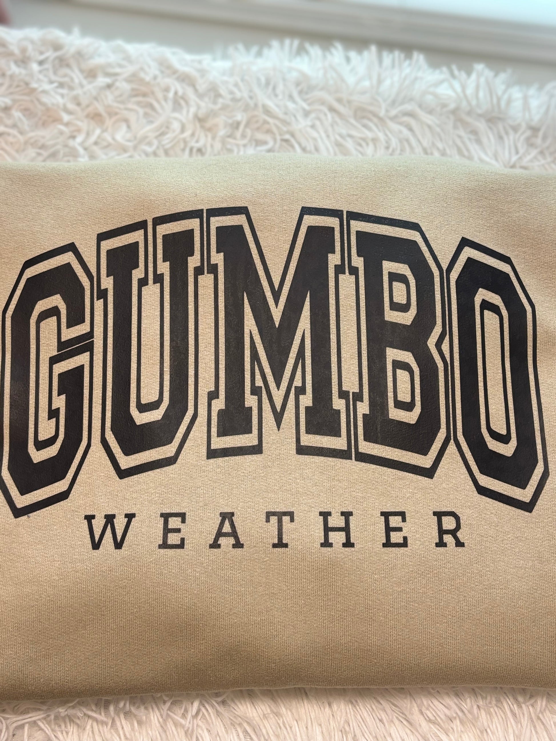 Beige heat press sweatshirt with 'GUMBO WEATHER' text in black