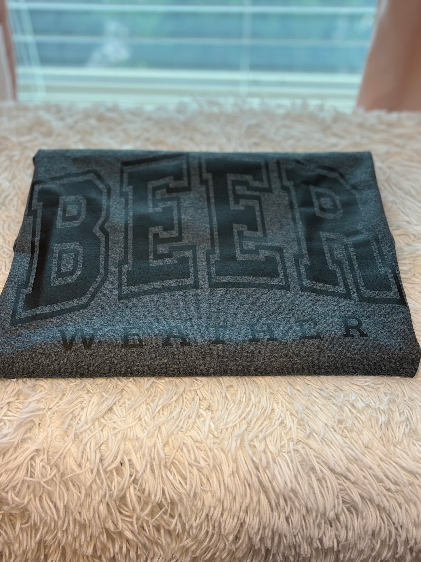 Dark heather heat press t-shirt with 'BEER WEATHER' text in black