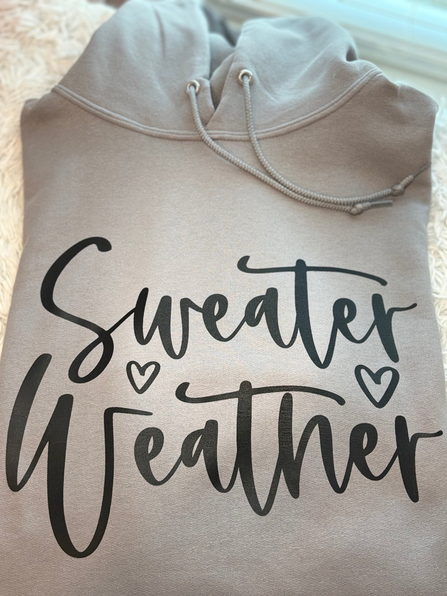Gray heat press hoodie with 'Sweater Weather' text in black