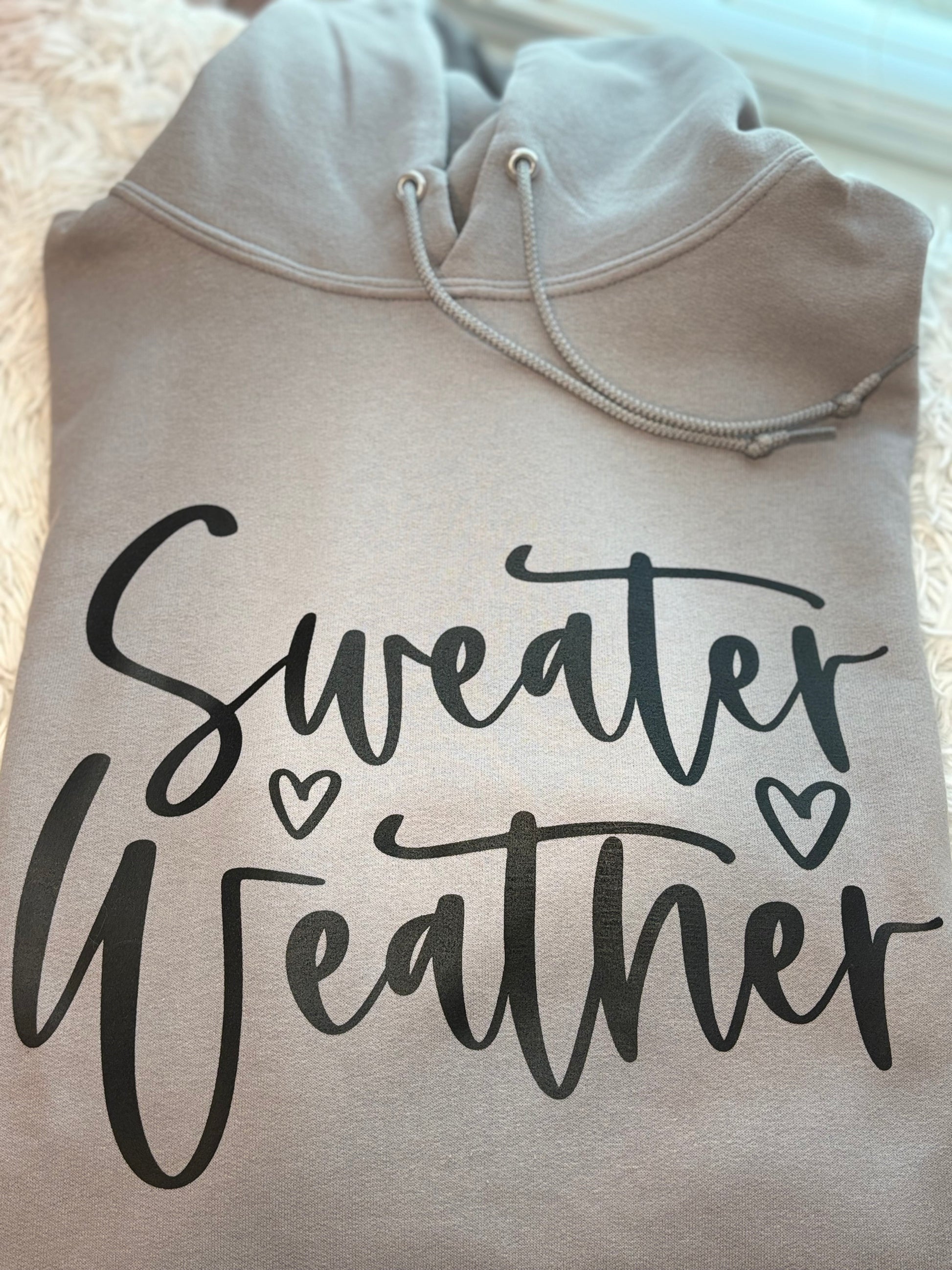 Gray heat press hoodie with 'Sweater Weather' text in black