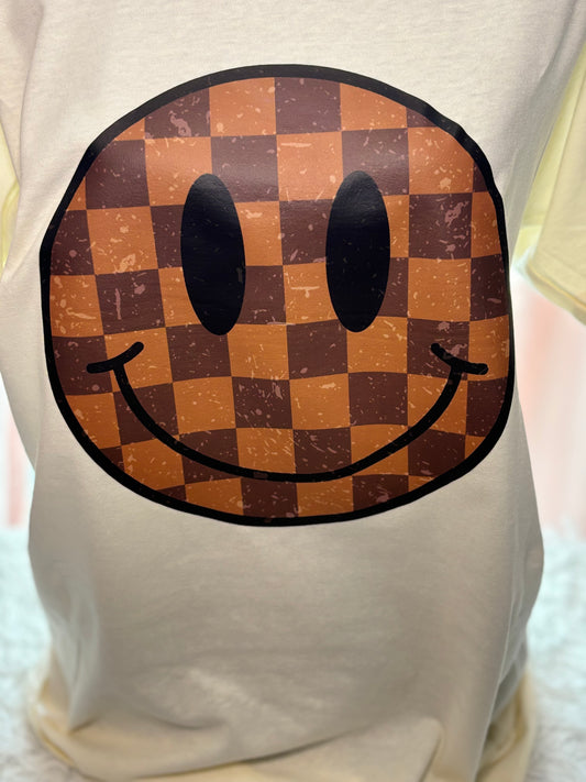 Cream heat press t-shirt with a checkered smiley face design