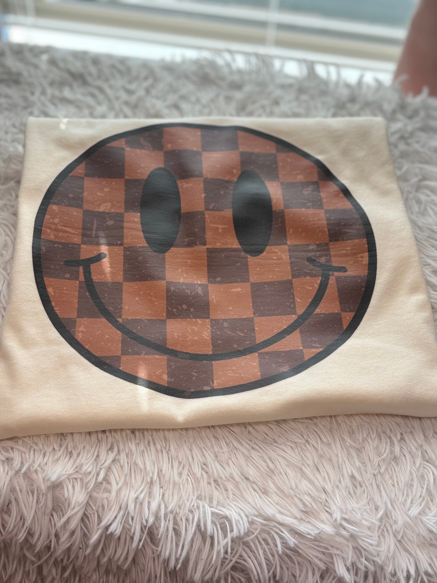 Cream heat press t-shirt with a checkered smiley face design