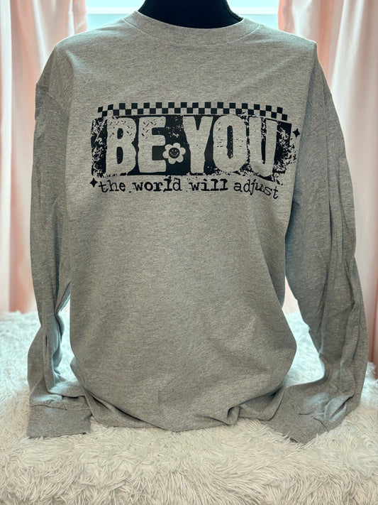 Gray heat press long sleeve t-shirt with 'Be You, the world will adjust' text in black- checker