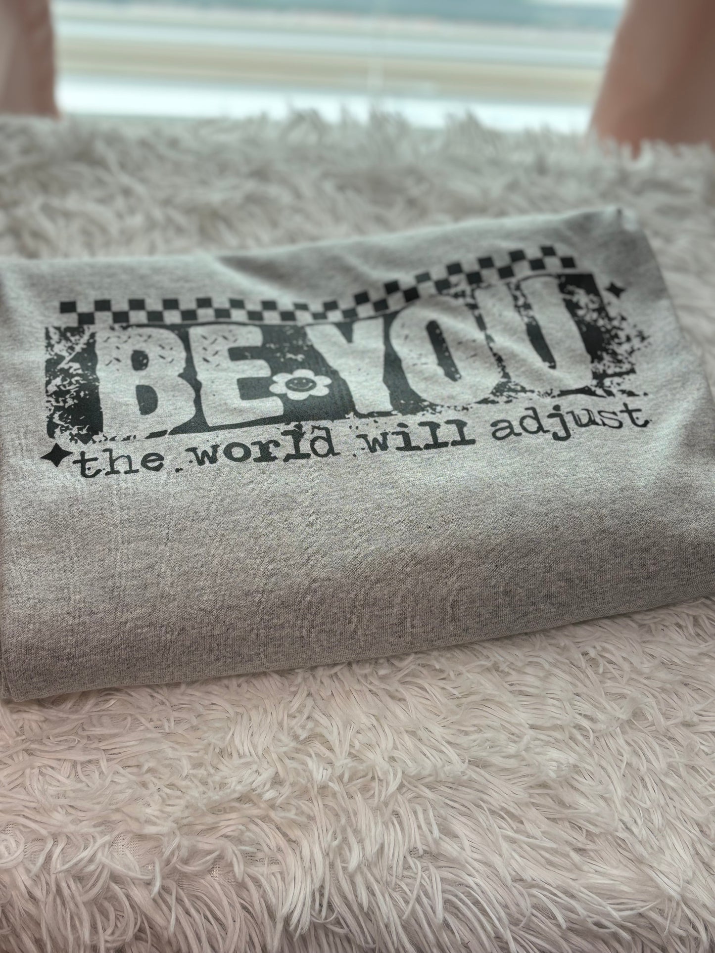 Gray heat press long sleeve t-shirt with 'Be You, the world will adjust' text in black- checker
