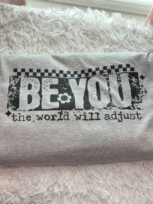 Gray heat press long sleeve t-shirt with 'Be You, the world will adjust' text in black- checker
