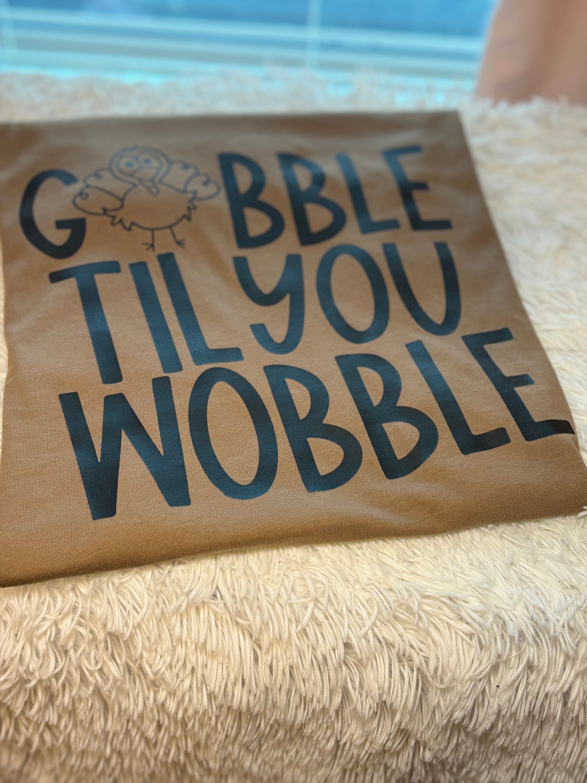 Brown heat press t-shirt with 'Gobble Til You Wobble' text and a turkey graphic