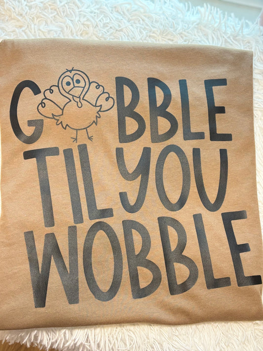Brown heat press t-shirt with 'Gobble Til You Wobble' text and a turkey graphic