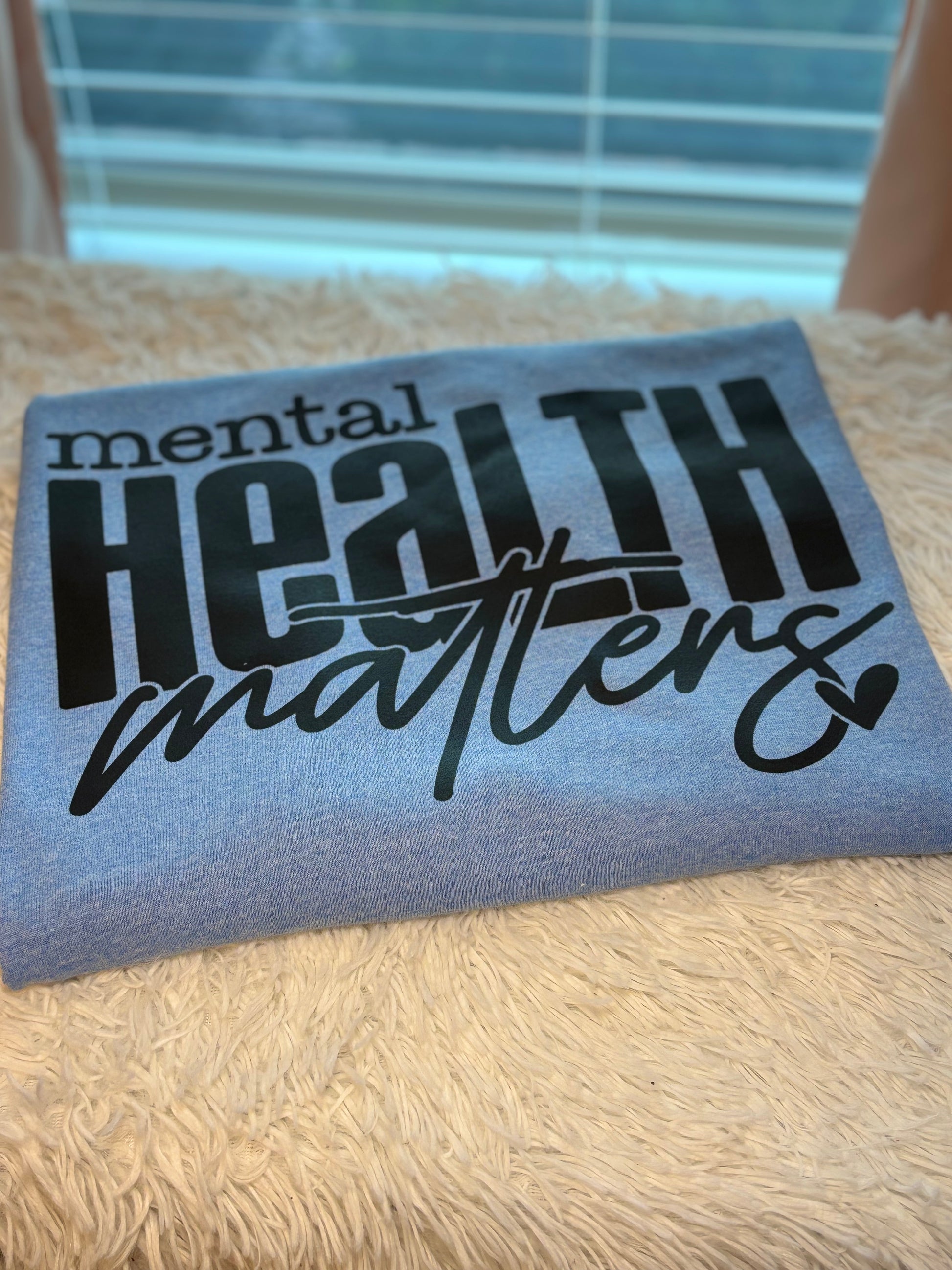 Light blue heat press t-shirt with 'mental health matters' text in black