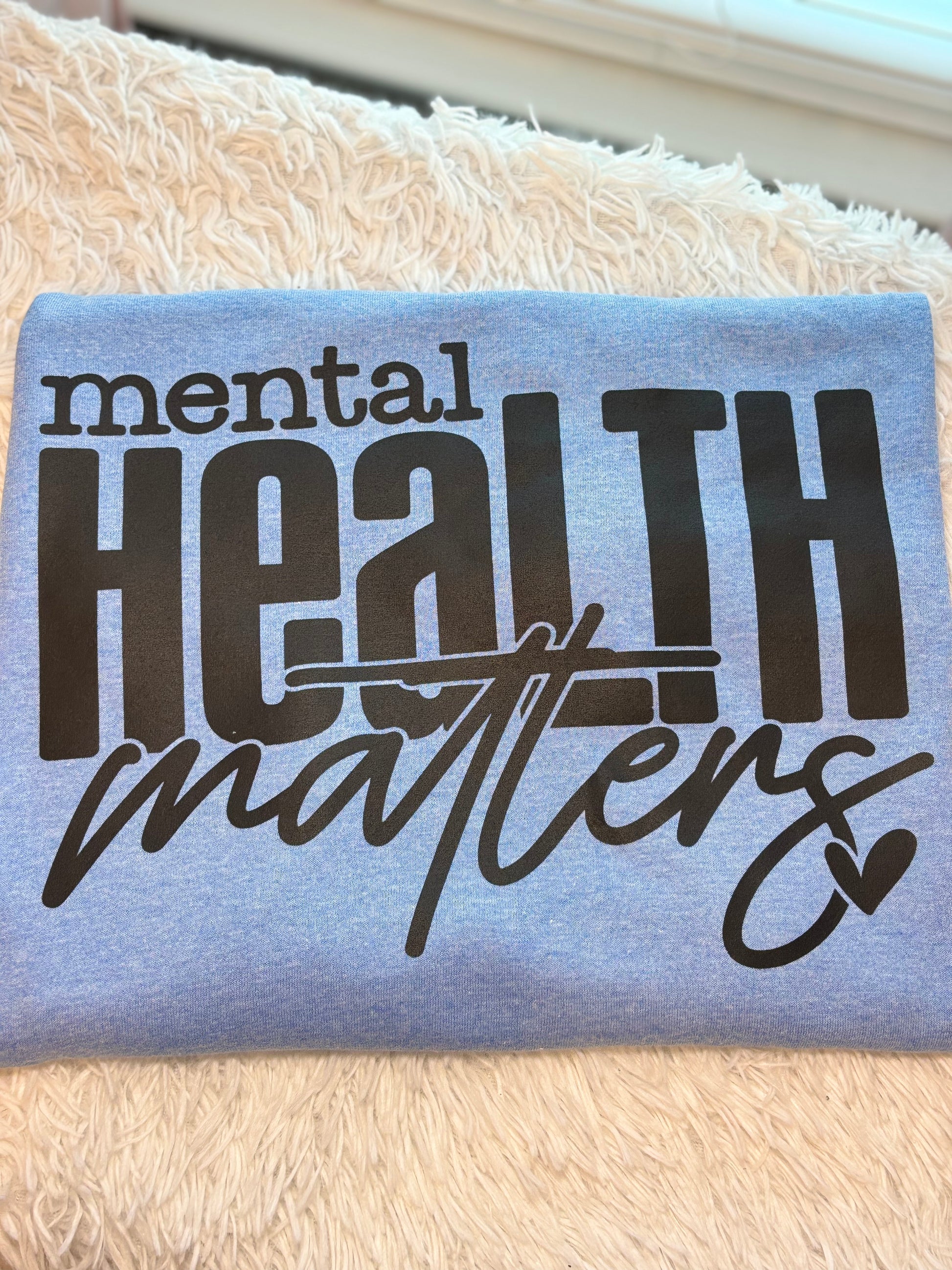 Light blue heat press t-shirt with 'mental health matters' text in black