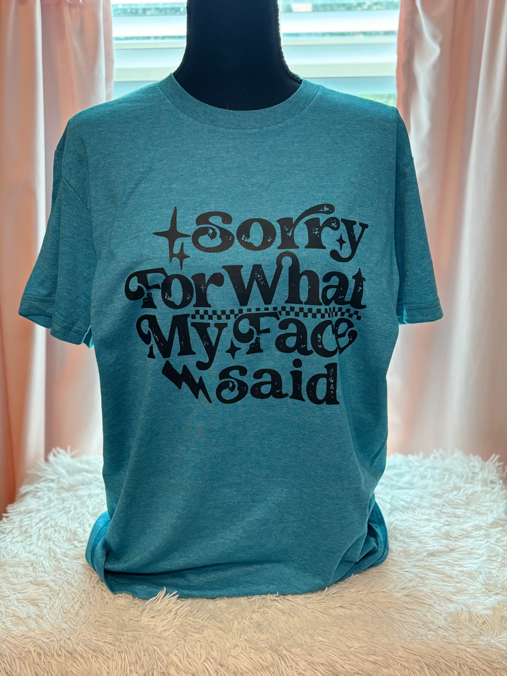 Blue heat press t-shirt with text 'Sorry For What My Face Said' in black