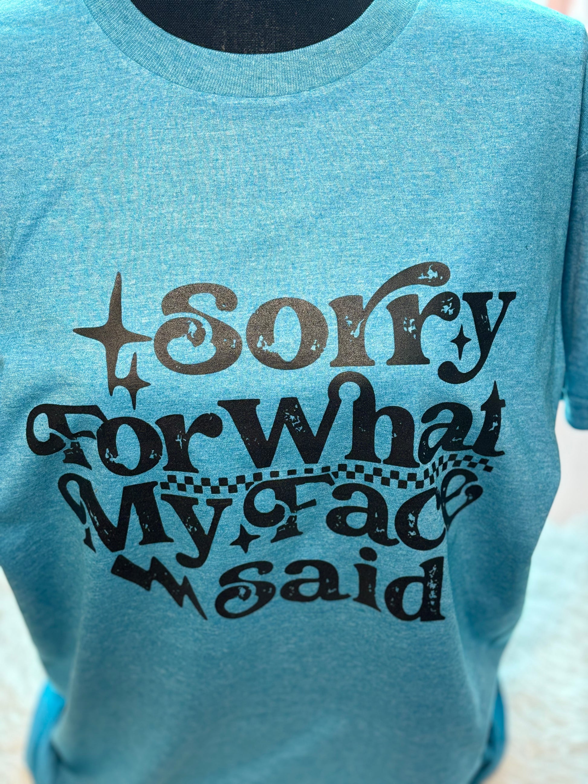 Blue heat press t-shirt with text 'Sorry For What My Face Said' in black