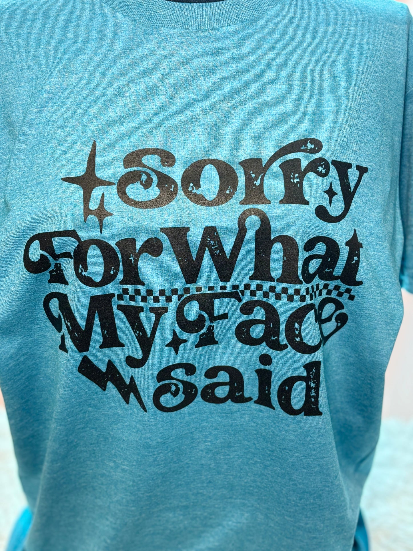 Blue heat press t-shirt with text 'Sorry For What My Face Said' in black