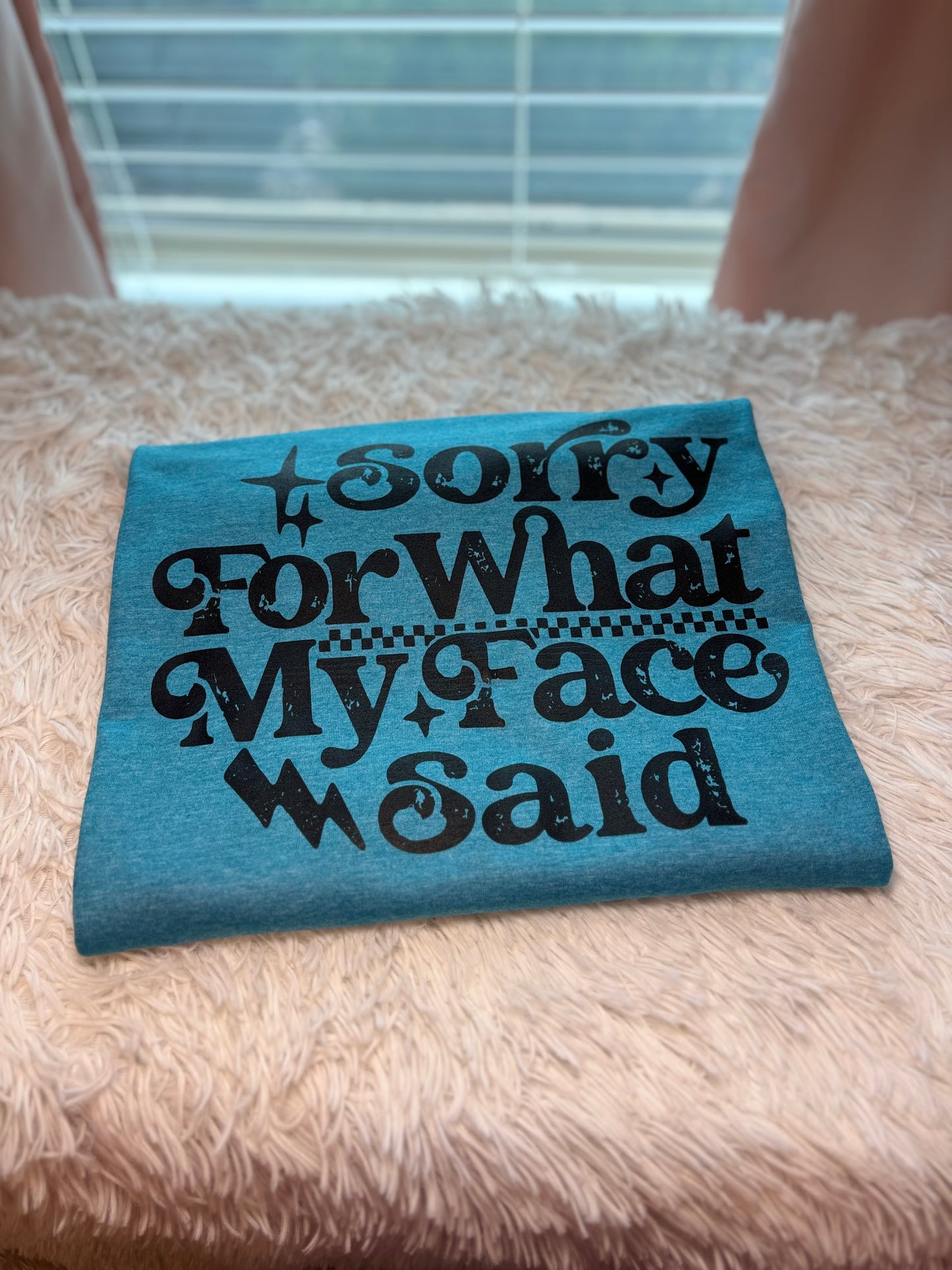 Blue heat press t-shirt with text 'Sorry For What My Face Said' in black