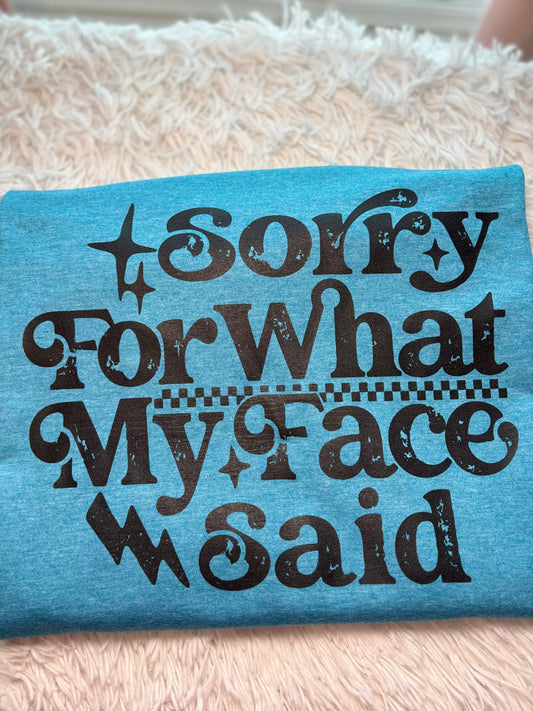 Blue heat press t-shirt with text 'Sorry For What My Face Said' in black