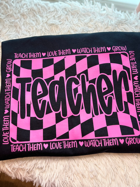 Pink and black checkered heat press t-shirt with 'Teacher' text
