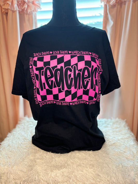 Pink and black checkered heat press t-shirt with 'Teacher' text
