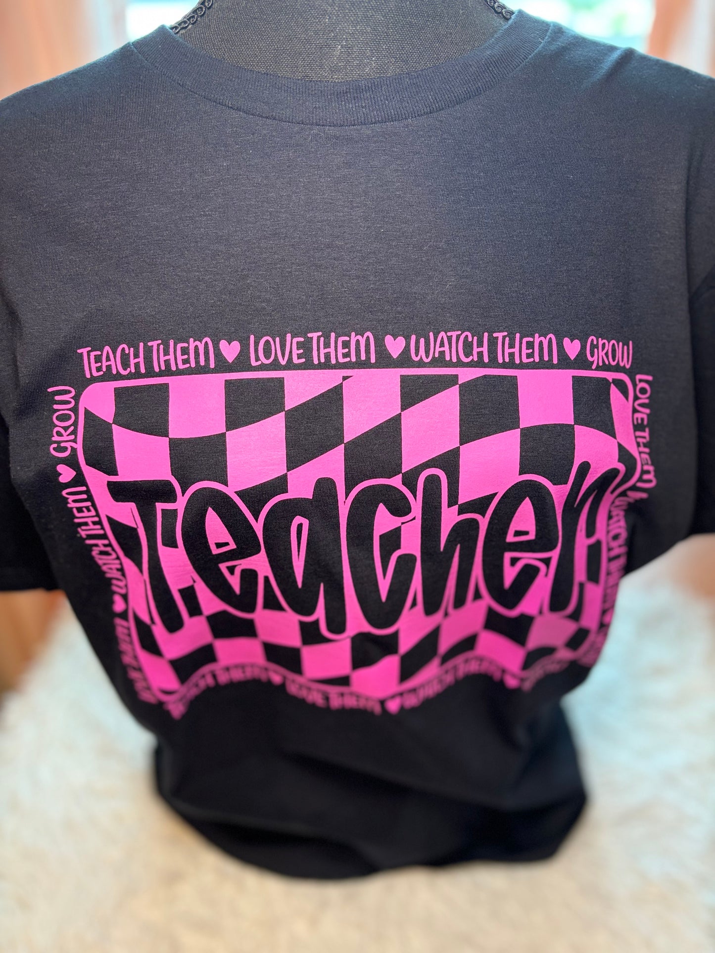 Pink and black checkered heat press t-shirt with 'Teacher' text