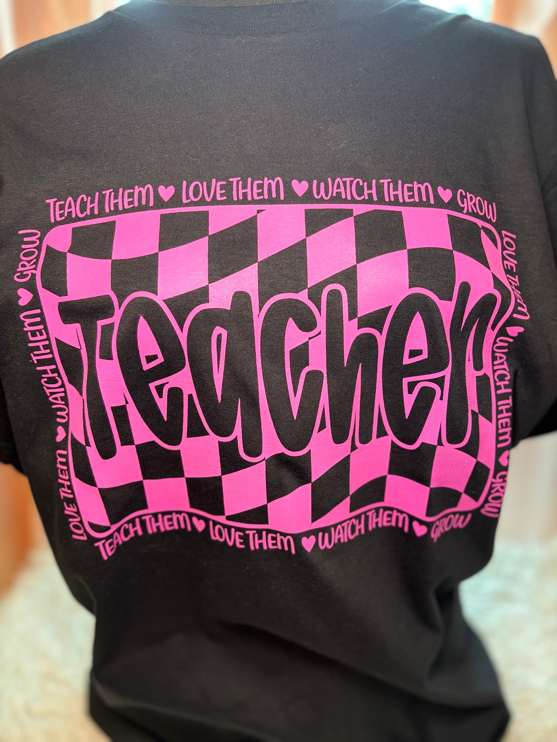 Pink and black checkered heat press t-shirt with 'Teacher' text