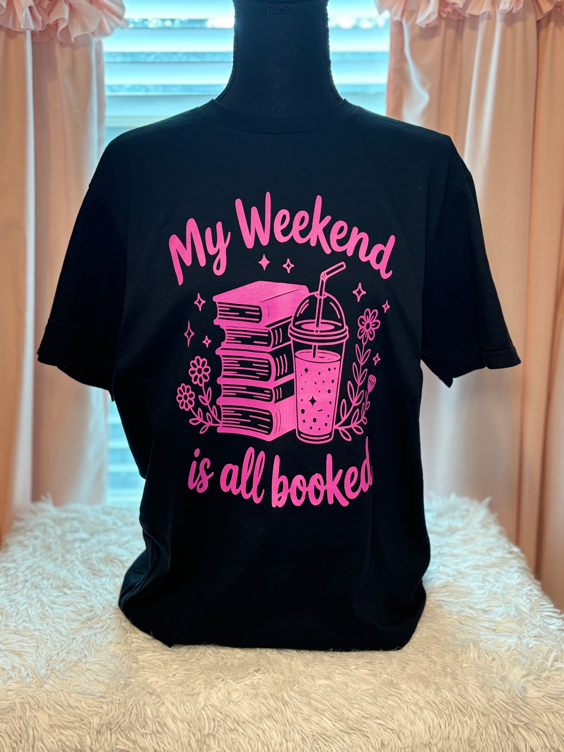Black heat press t-shirt with neon pink text and graphics - My Weekend is all booked with books. coffee, and flowers