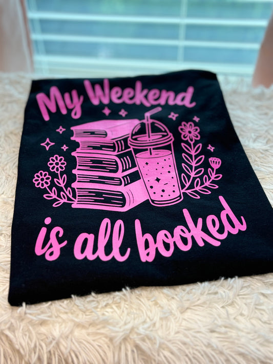 Black heat press t-shirt with neon pink text and graphics - My Weekend is all booked with books. coffee, and flowers