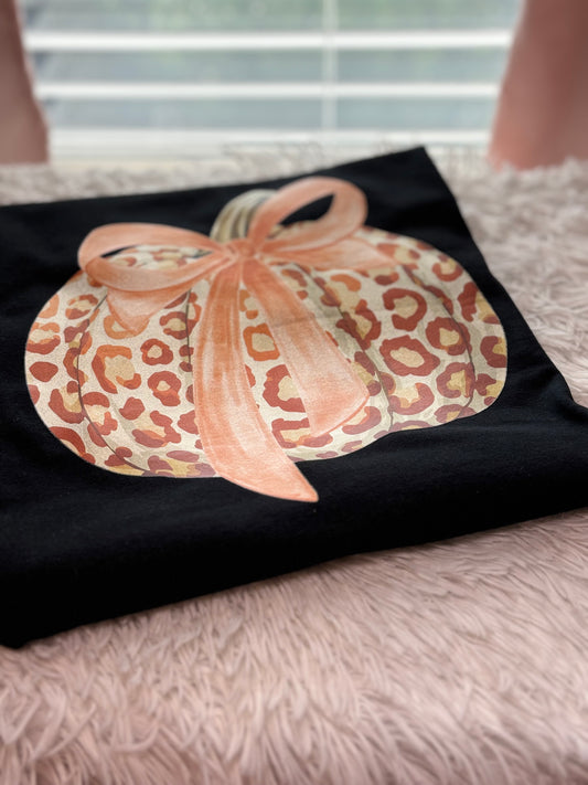 Black t-shirt with a heat press glitter leopard print pumpkin design