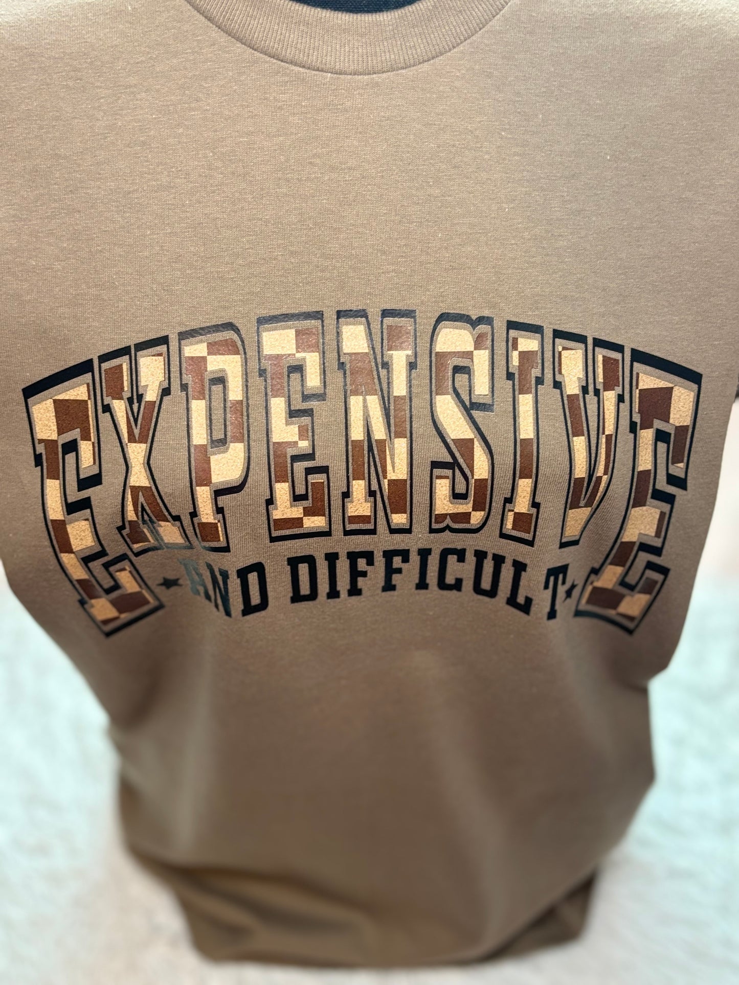 Brown heat press t-shirt with text 'EXPENSIVE AND DIFFICULT' - checkered