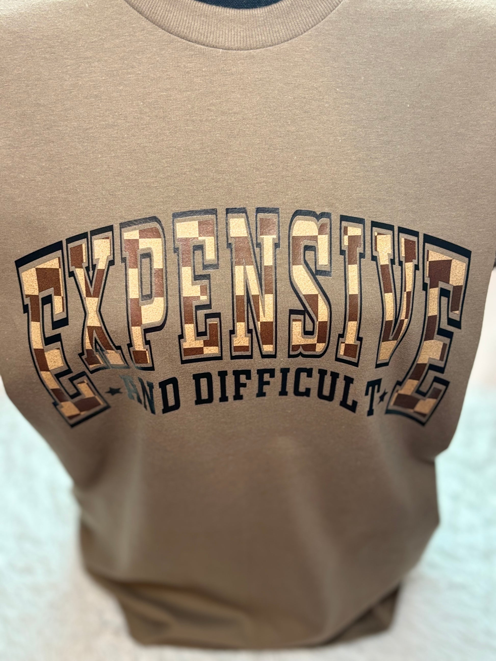 Brown heat press t-shirt with text 'EXPENSIVE AND DIFFICULT' - checkered