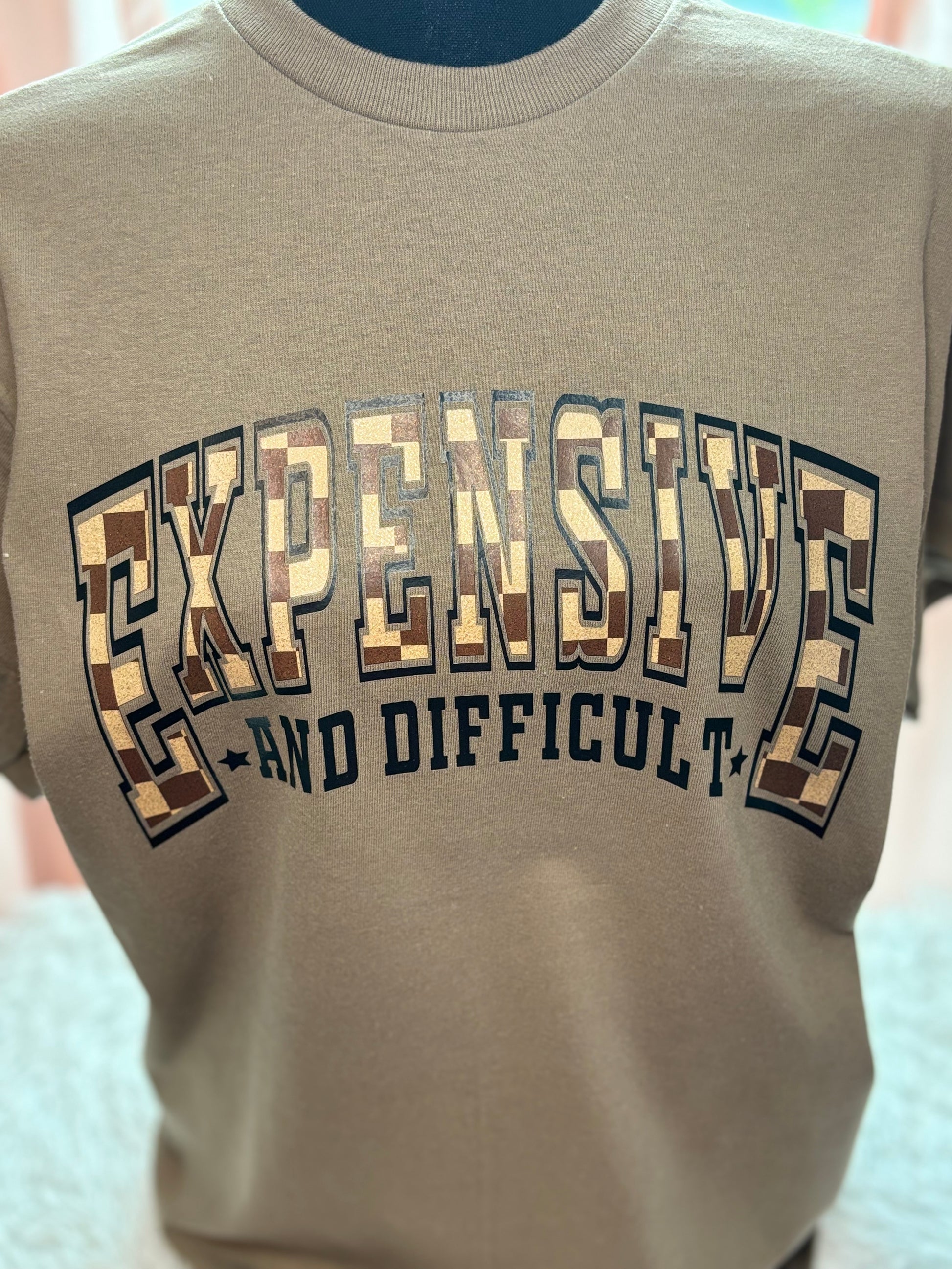 Brown heat press t-shirt with text 'EXPENSIVE AND DIFFICULT' - checkered