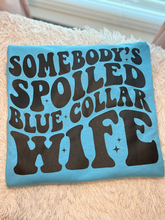 Aqua heat press t-shirt with text 'Somebody's Spoiled Blue Collar Wife' in black