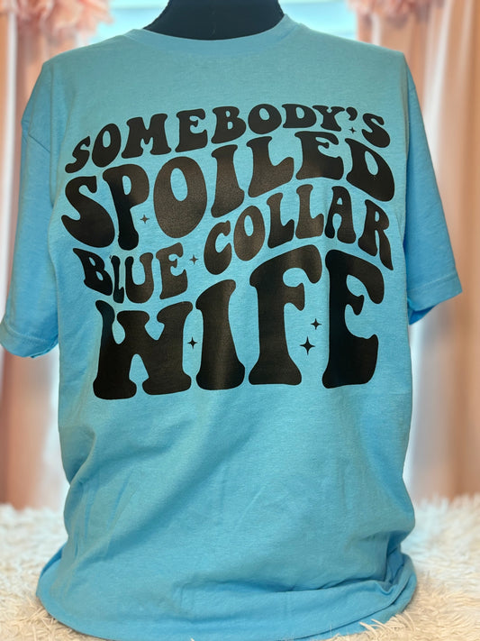 Aqua heat press t-shirt with text 'Somebody's Spoiled Blue Collar Wife' in black