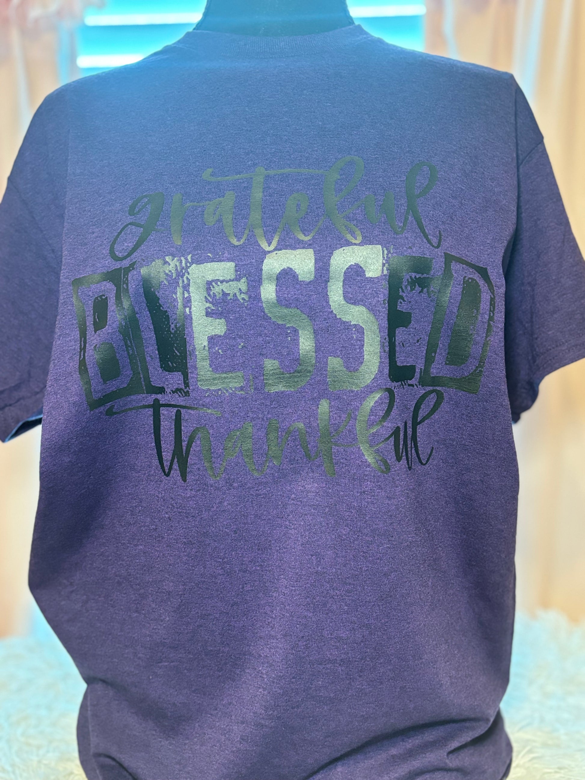 Purple heat press t-shirt with 'grateful blessed thankful' text in black