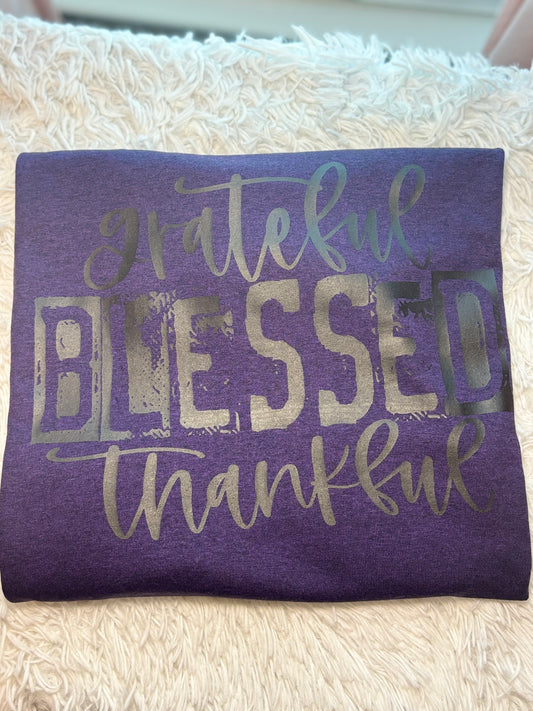 Purple heat press t-shirt with 'grateful blessed thankful' text in black