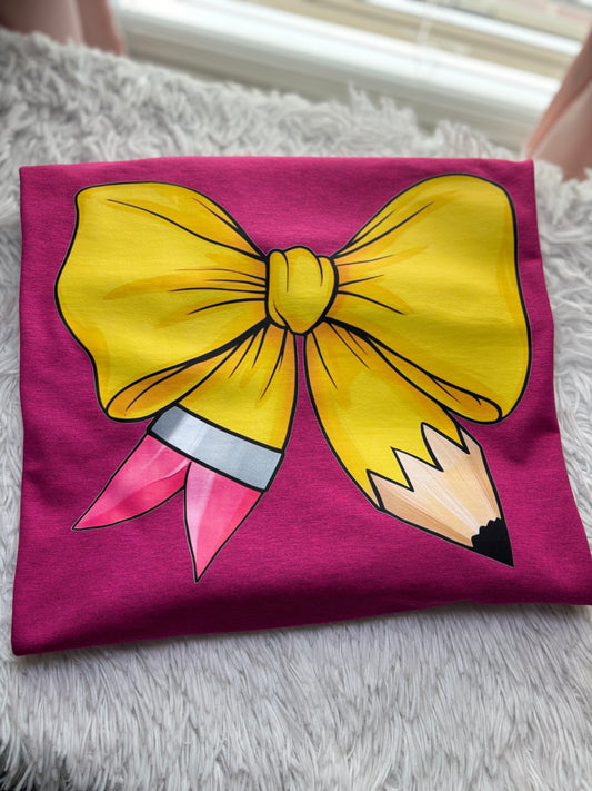 Pink heat press t-shirt with a large yellow pencil bow design