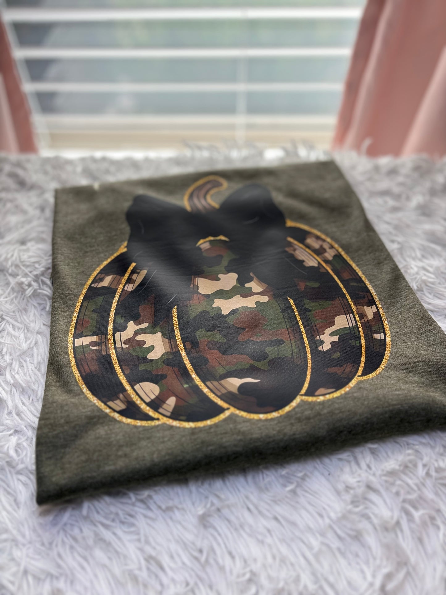Military green t-shirt with a heat press camouflage pumpkin with bow and outlined in gold