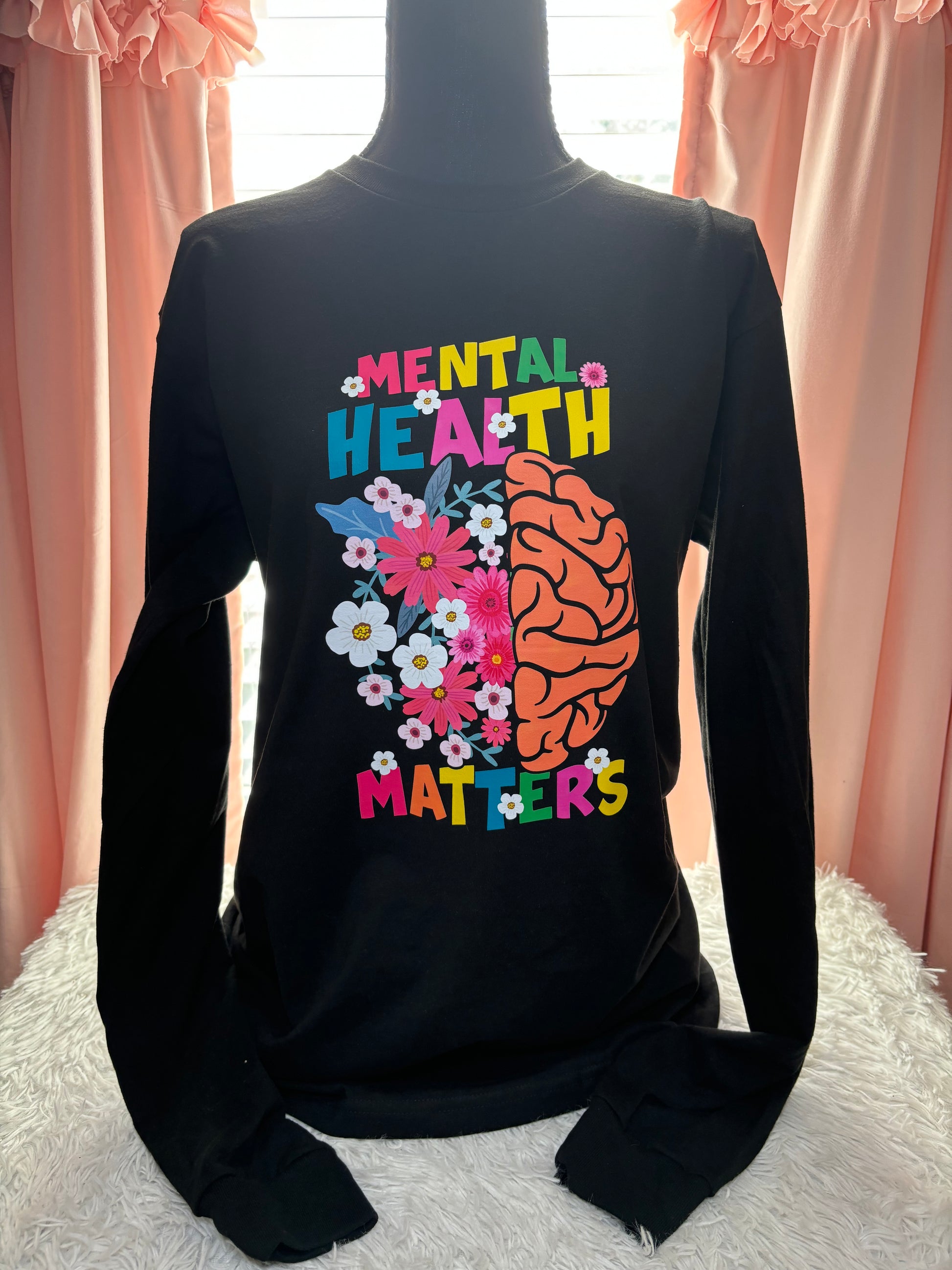 Black long sleeve heat press t-shirt with a colorful brain and flowers design and 'Mental Health Matters' text.