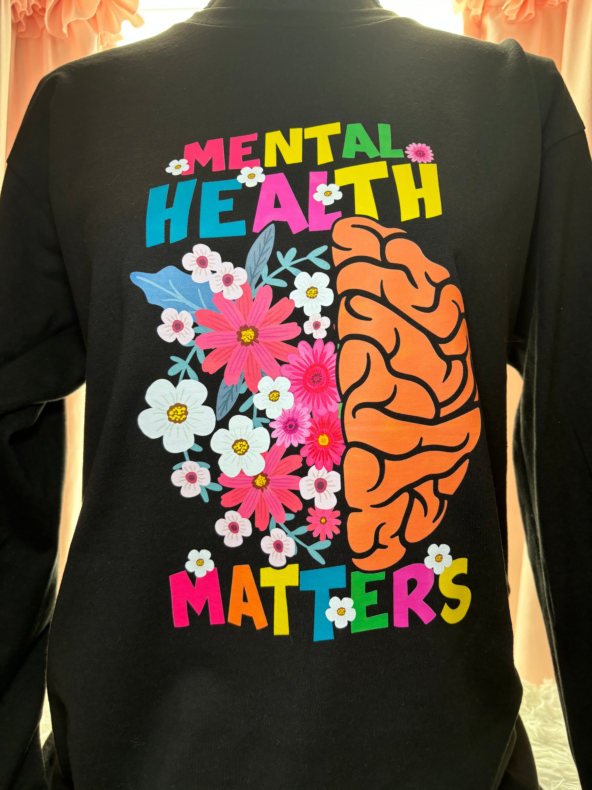 Black long sleeve heat press t-shirt with a colorful brain and flowers design and 'Mental Health Matters' text.