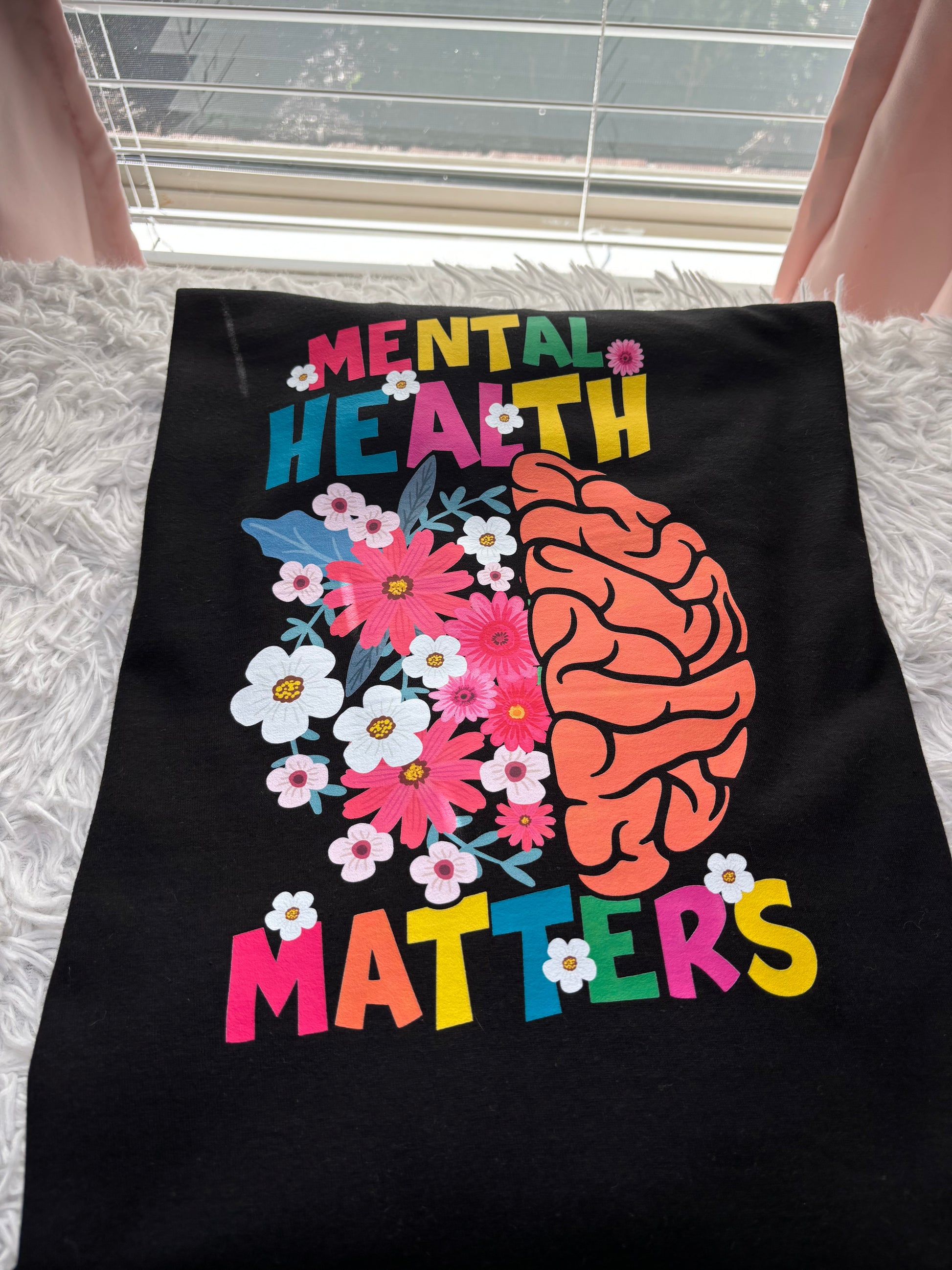 Black long sleeve heat press t-shirt with a colorful brain and flowers design and 'Mental Health Matters' text.