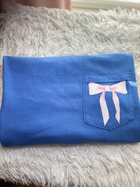 Blue heat press pocket t-shirt with colorful bows and 'She is strong' text on the back and bow on the front pocket