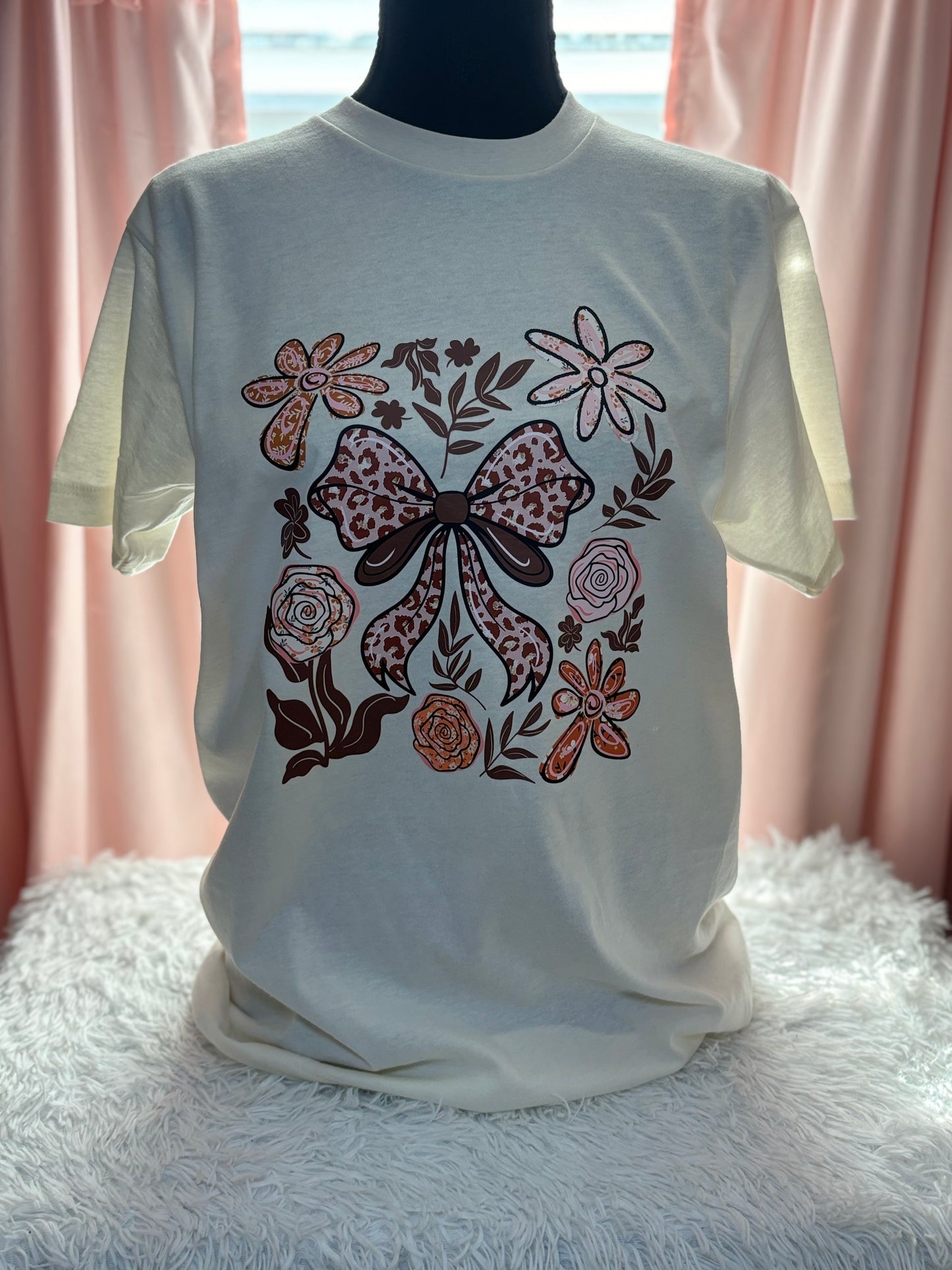 Beige t-shirt with a decorative heat press bow and floral patterns