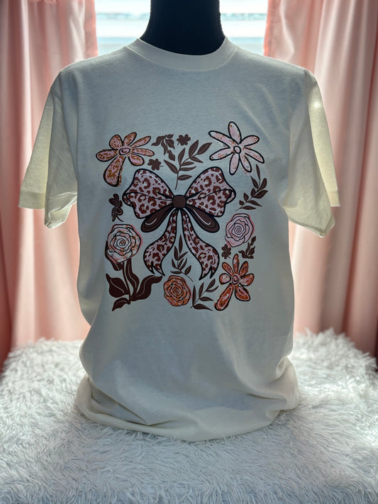 Beige t-shirt with a decorative heat press bow and floral patterns