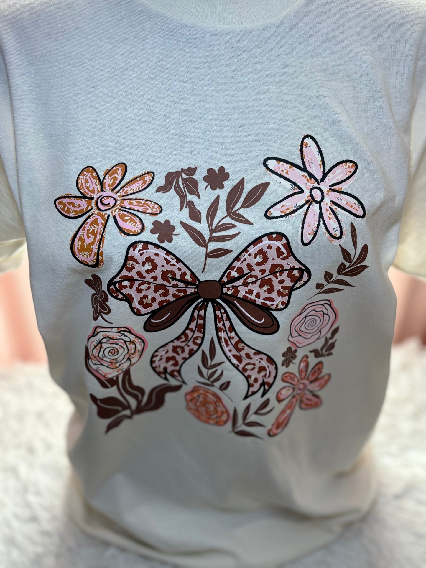 Beige t-shirt with a decorative heat press bow and floral patterns