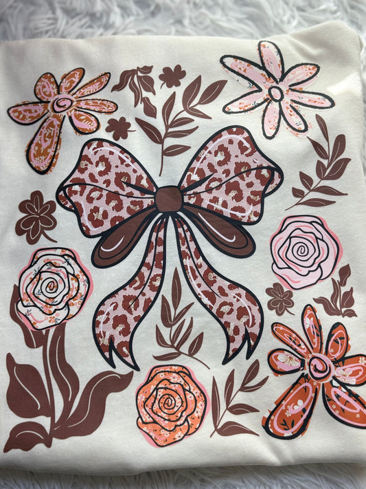 Beige t-shirt with a decorative heat press bow and floral patterns