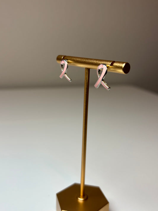 Pink ribbon earrings on a silver background