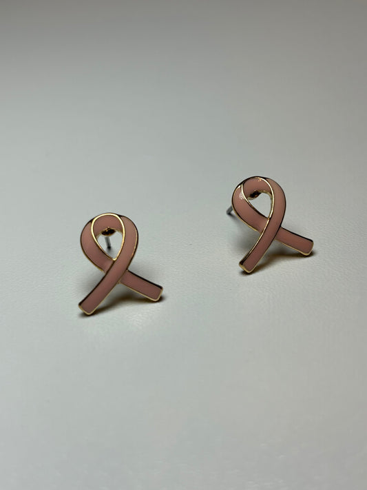 Pink ribbon earrings on a gold background