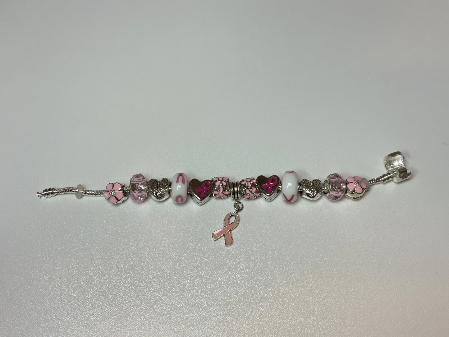 Silver bracelet with pink ribbon and flower charms