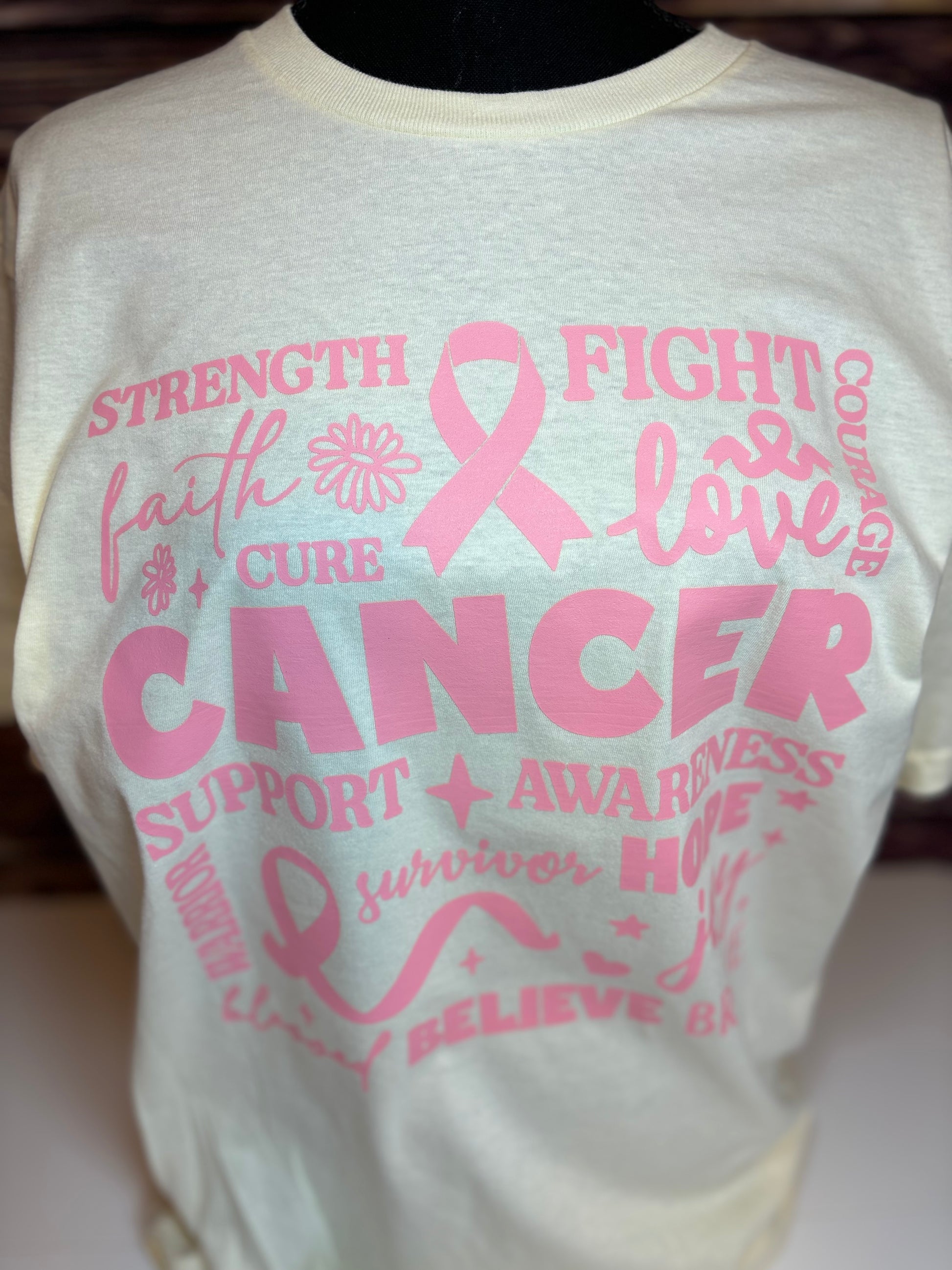 Off white heat pressed t-shirt with pink cancer awareness text and symbols