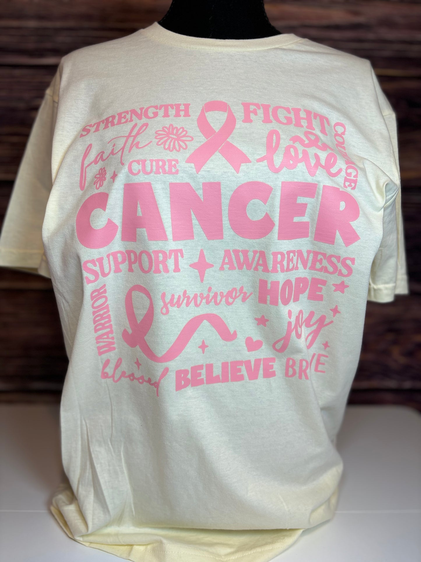 Off white heat pressed t-shirt with pink cancer awareness text and symbols