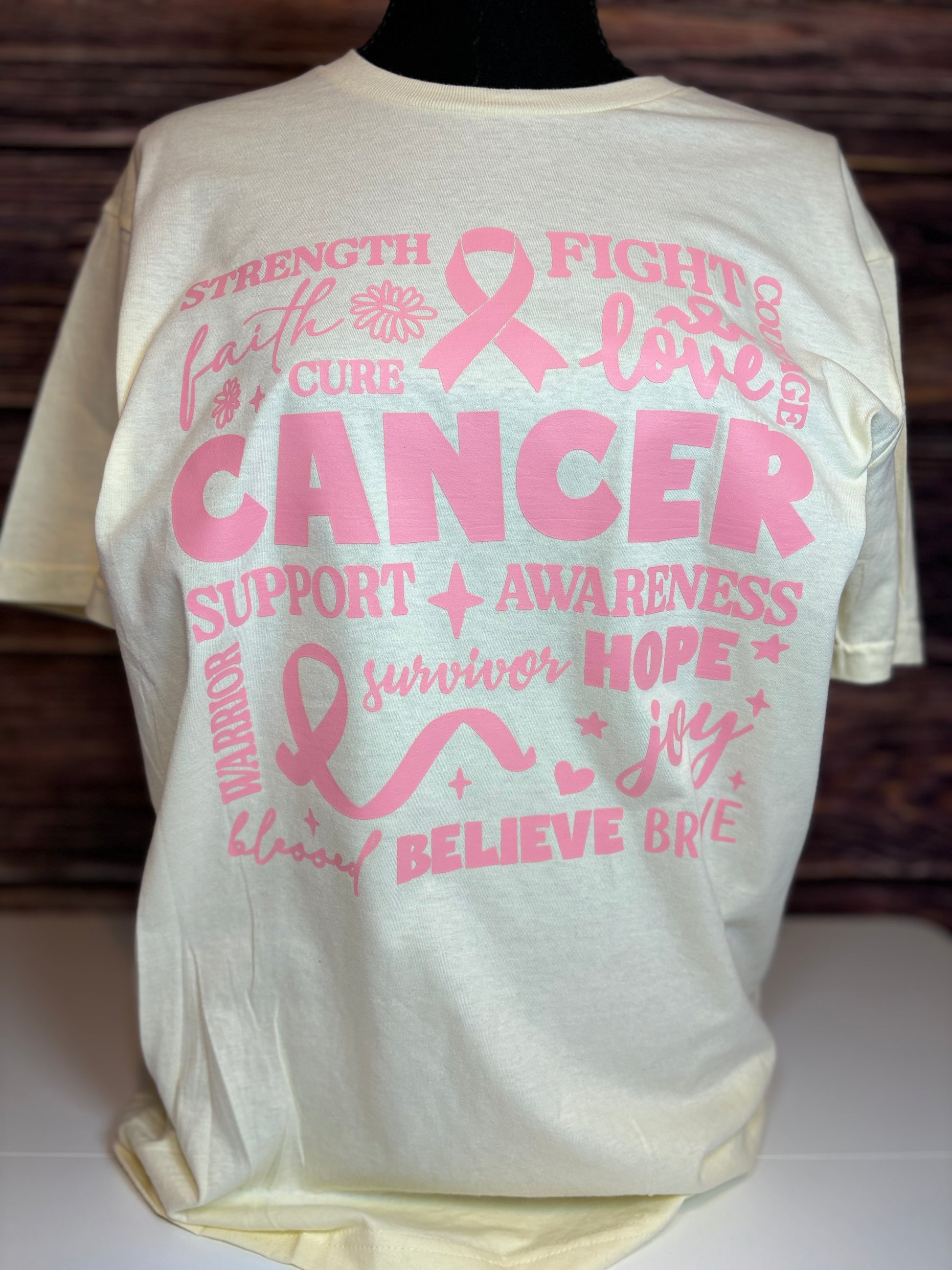 Off white heat pressed t-shirt with pink cancer awareness text and symbols