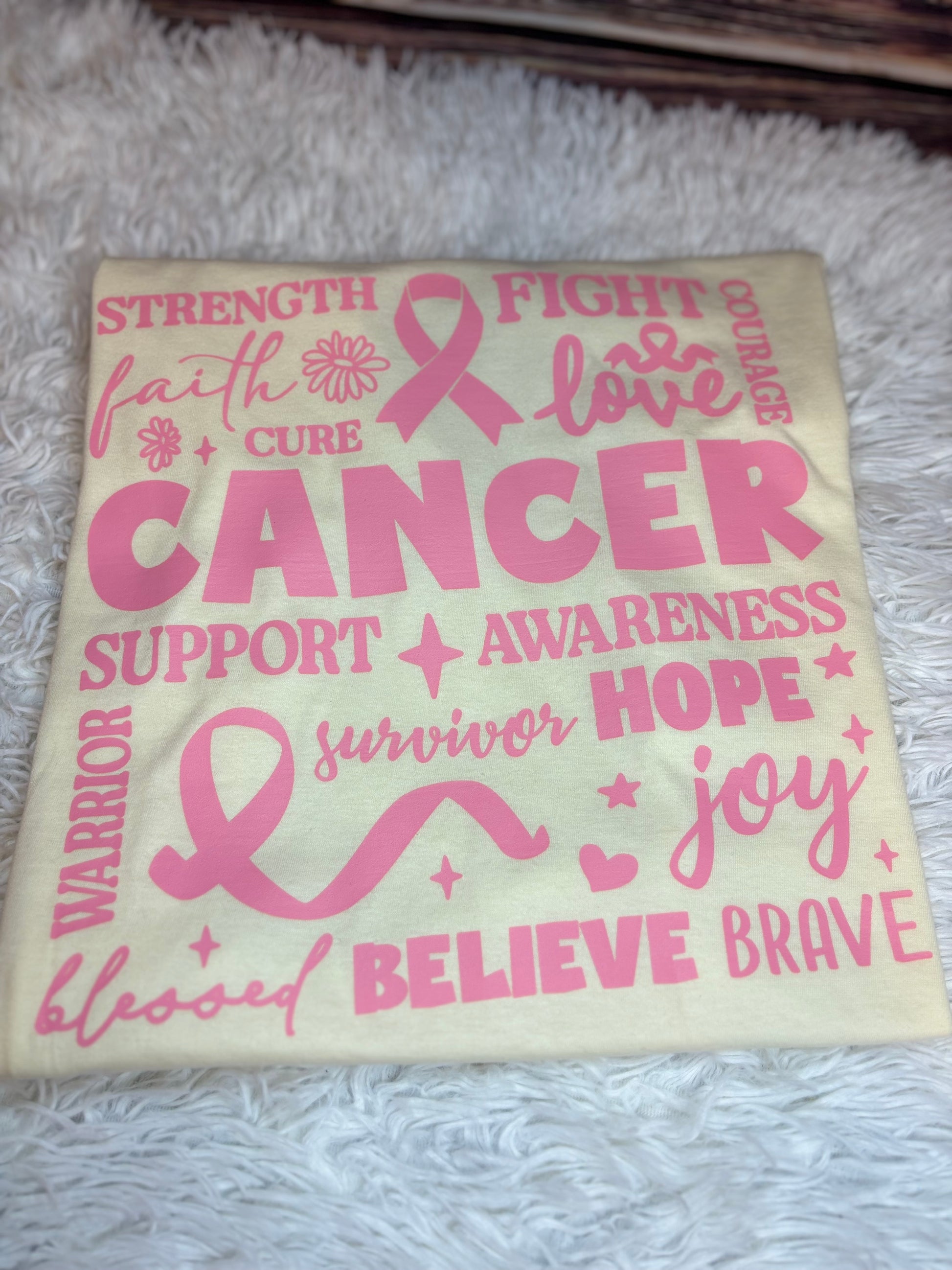 Off white heat pressed t-shirt with pink cancer awareness text and symbols