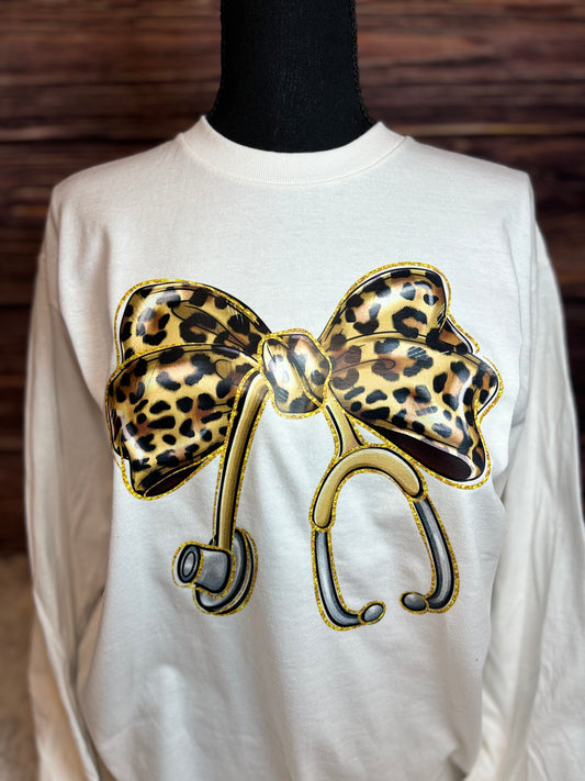White long sleeve heat pressed t-shirt with a large leopard print bow nurse stethoscope design
